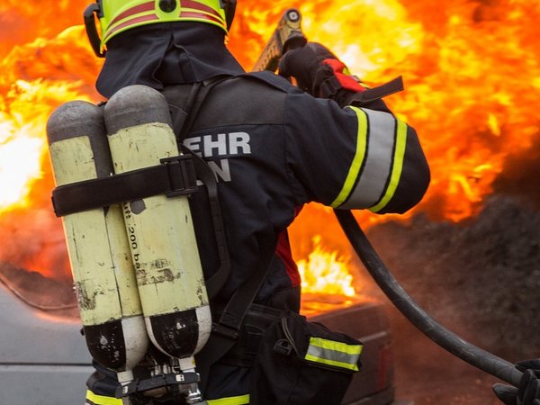 Feuerwehrmann löscht brennendes Auto